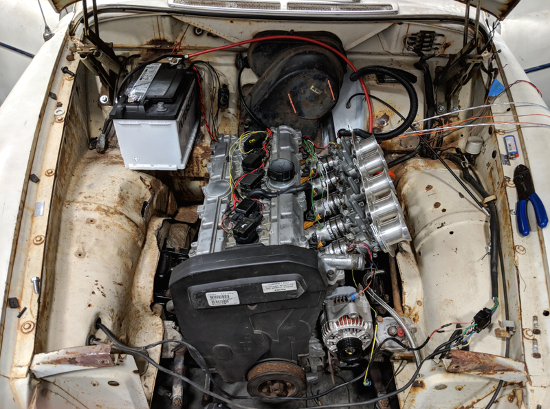 Fitting the new 850-sourced engine in the engine bay.